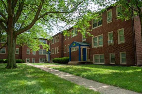 A brick building with a blue door and windows.