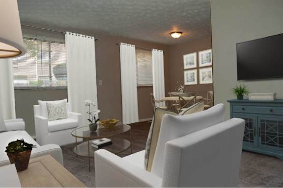 A living room with white chairs and a wooden coffee table.