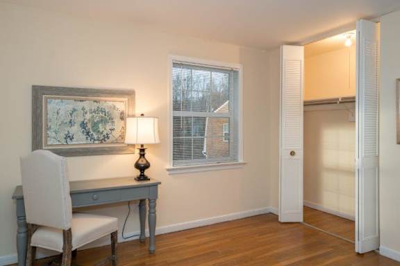 A room with a desk and chair in it.