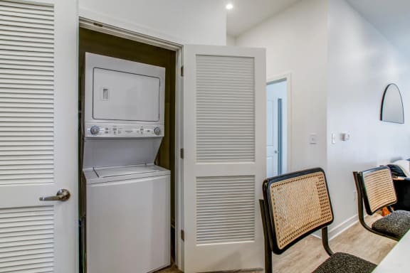 a laundry room with a washer and dryer next to a door