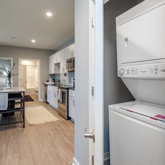 a laundry room with a washer and dryer and a kitchen