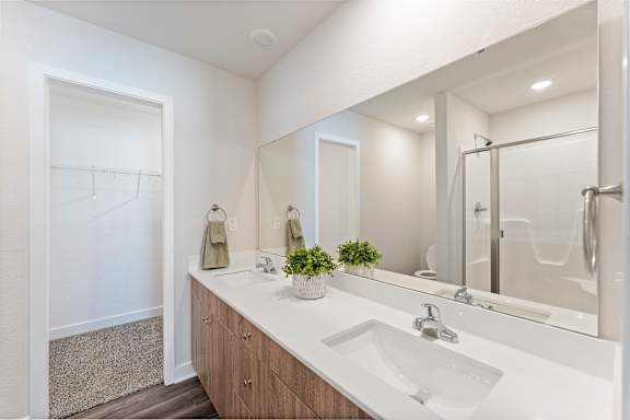 A bathroom with a white sink and a mirror.