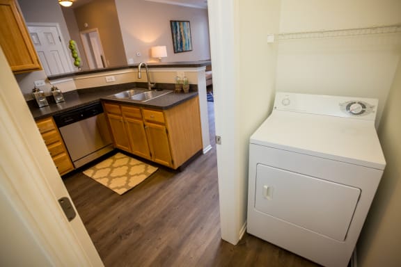 a full view of a kitchen with a washer and dryer in it