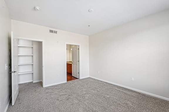A room with a white door and a white shelf.