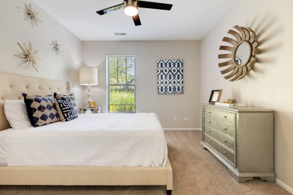 a bedroom with a large bed and a ceiling fan