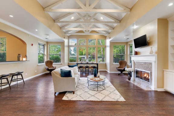 a large living room with a fireplace and a tv