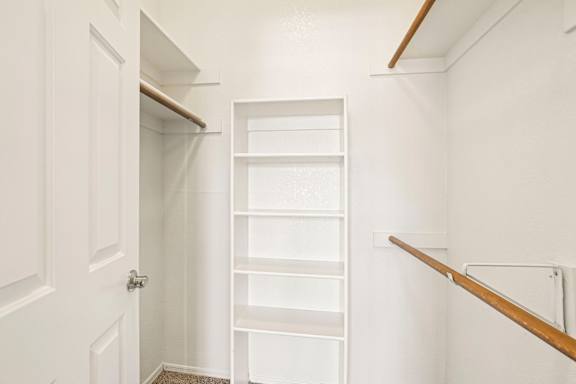 Walk-in closet — representative home at The Palms.