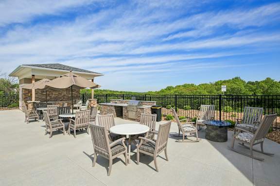A patio with a table and chairs and a gazebo.