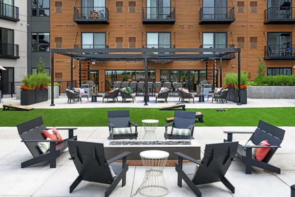 a patio with tables and chairs in front of a building