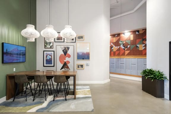 a dining room with a table and chairs and art on the wall