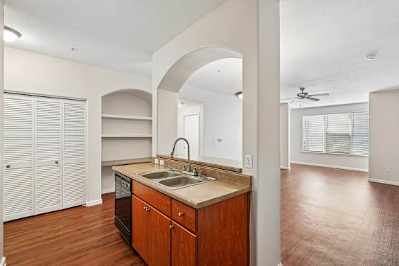 A kitchen with wooden cabinets and a sink.