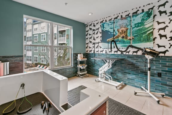 a bathroom with a tub and a sink and a wall mural