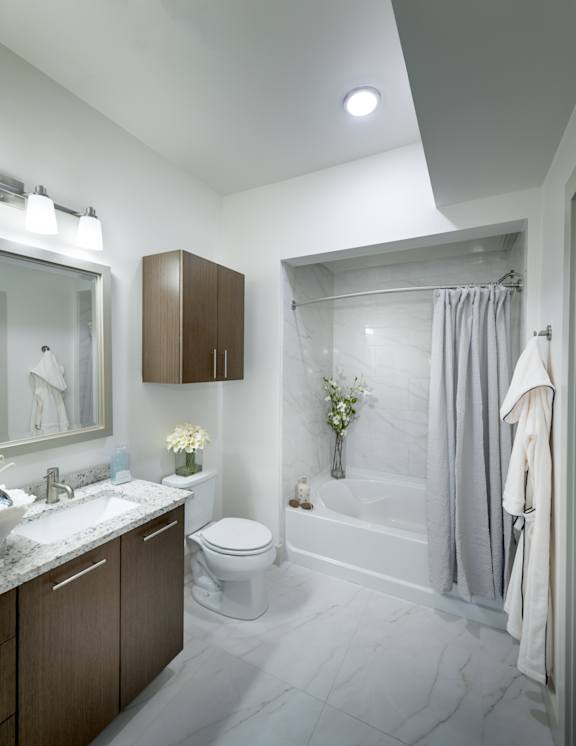 Bathroom with large tub, sink, and mirror