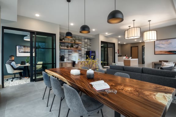a dining room with a wooden table and chairs