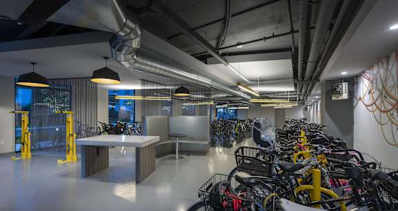 A room with a large number of bicycles parked inside.