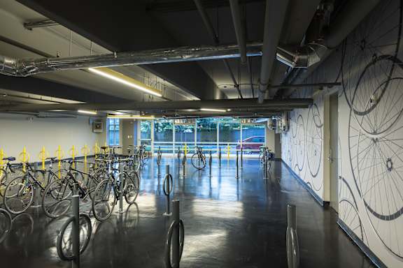 A bike rack with bicycles in a parking area.