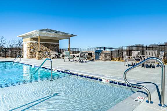 A pool with a small building next to it.