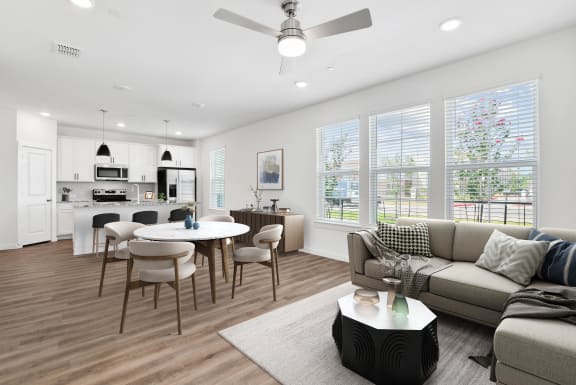 Large living area with tons of natural light and hardwood style flooring