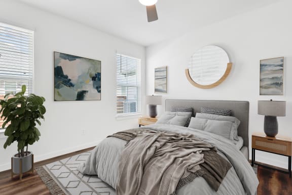 a bedroom with a large bed and white walls
