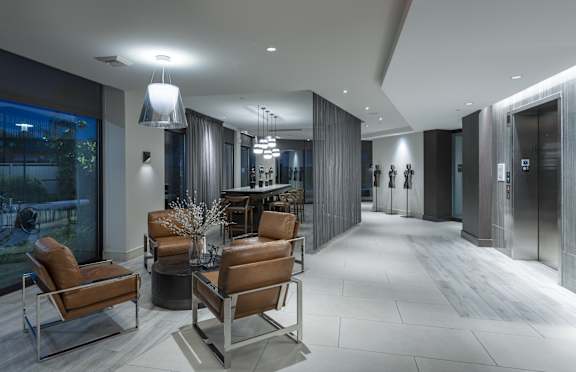 A modern living room with a long table and chairs.