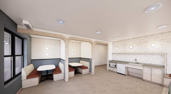 A kitchen area with a sink, stove, and cabinets.