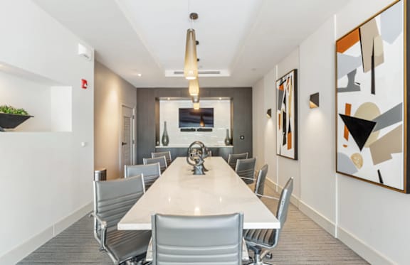 A conference room with a long table and chairs.