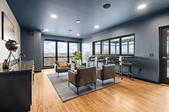 A modern kitchen with a dining area and a view of the outdoors.