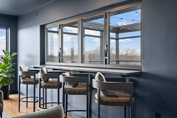 A bar area with four chairs and a counter.