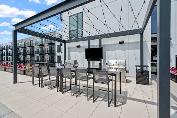 A patio with a table and chairs under a white awning.