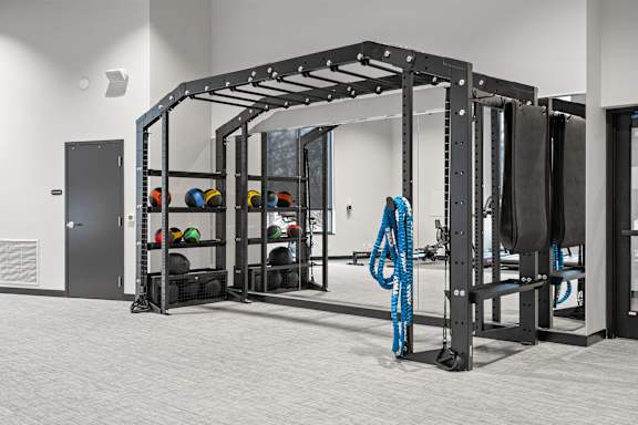 A gym with a blue rope hanging from a metal rack.
