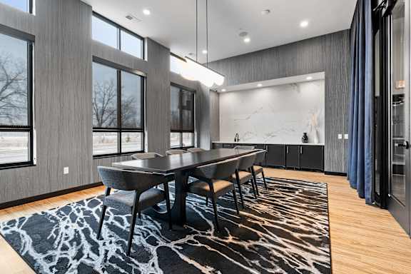A modern dining room with a large table and chairs.