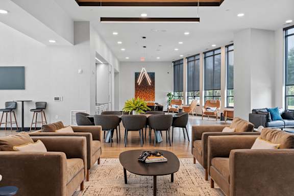 A living room with brown couches and a coffee table.
