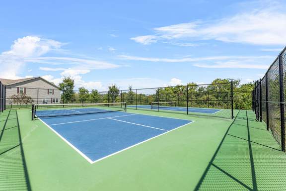 A tennis court with a blue surface and white lines.