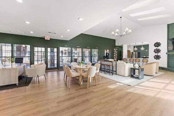 A spacious room with wooden floors and furniture.