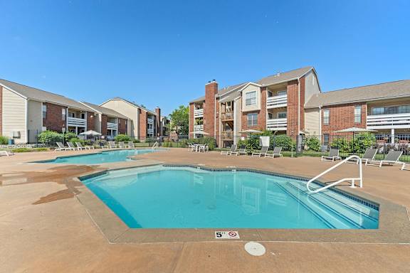 A swimming pool in front of apartment buildings.