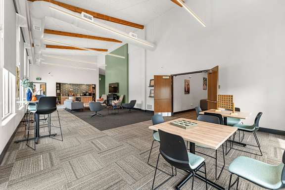 A conference room with a long table and chairs.