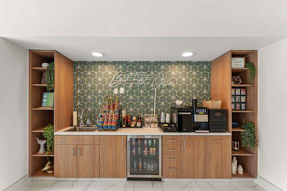 A kitchen with wooden cabinets and a green patterned backsplash.