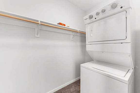 A white oven and dryer in a small room.