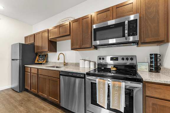 A kitchen with wooden cabinets and stainless steel appliances.