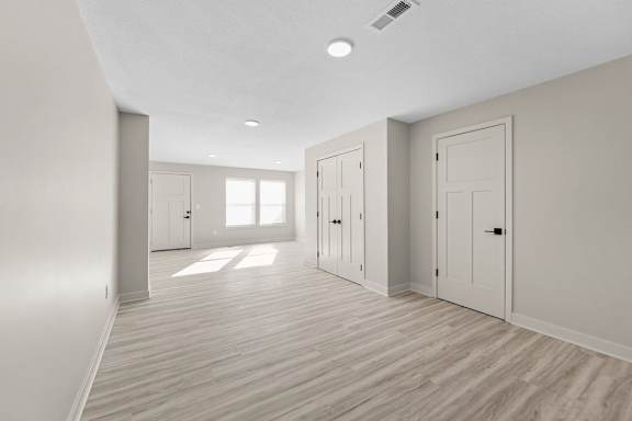 A room with wooden floors and white walls.