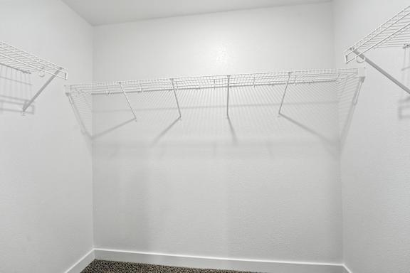Three wire shelves are mounted on the wall.