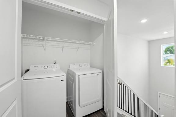 A white laundry room with a washer and dryer.