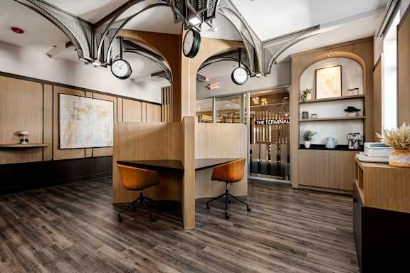 A modern office space with wood floors and furniture.