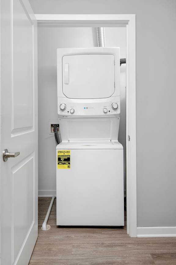 A white washing machine is in a doorway.