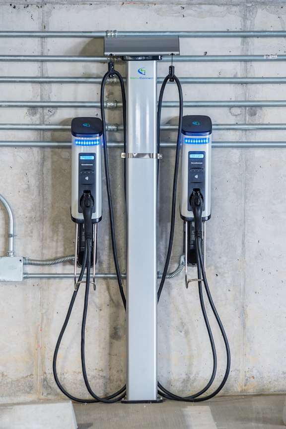 Two electric vehicle charging stations are installed on a wall.