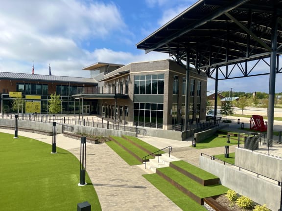 a large building with a lawn in front of it