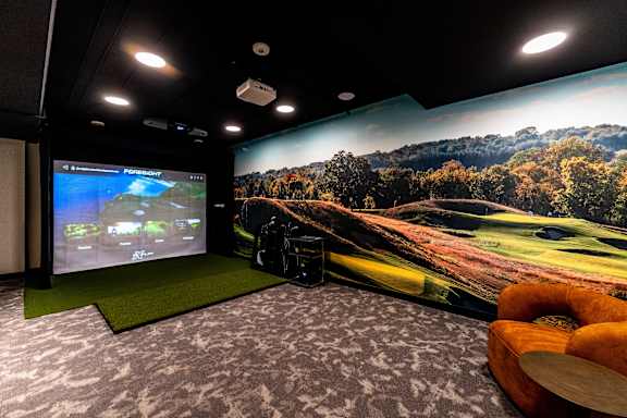 A room with a screen and a projector.