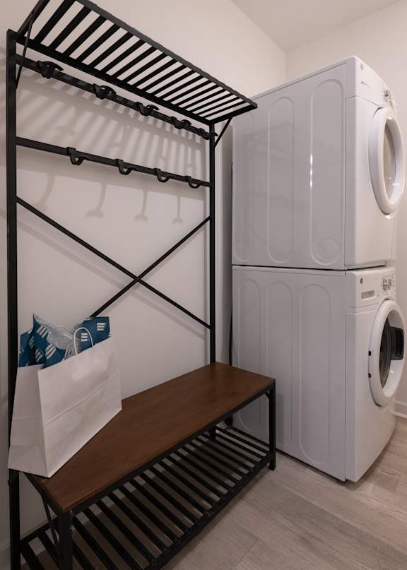 A laundry room with a washer and dryer stacked on top of each other.