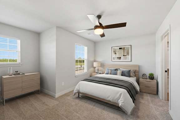 A bedroom with a bed, nightstand, and a ceiling fan.