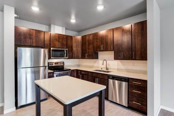 a kitchen with stainless steel appliances and wooden cabinets
